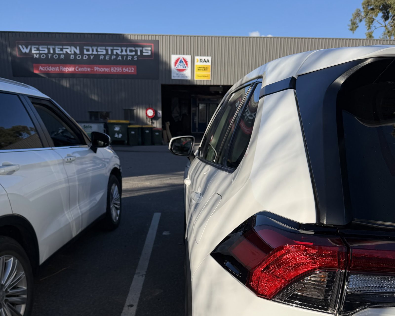 The Western Districts Motor Body Repairs building with its Accident Repair Centre sign and RAA Approved Repairer and CarCraft signs